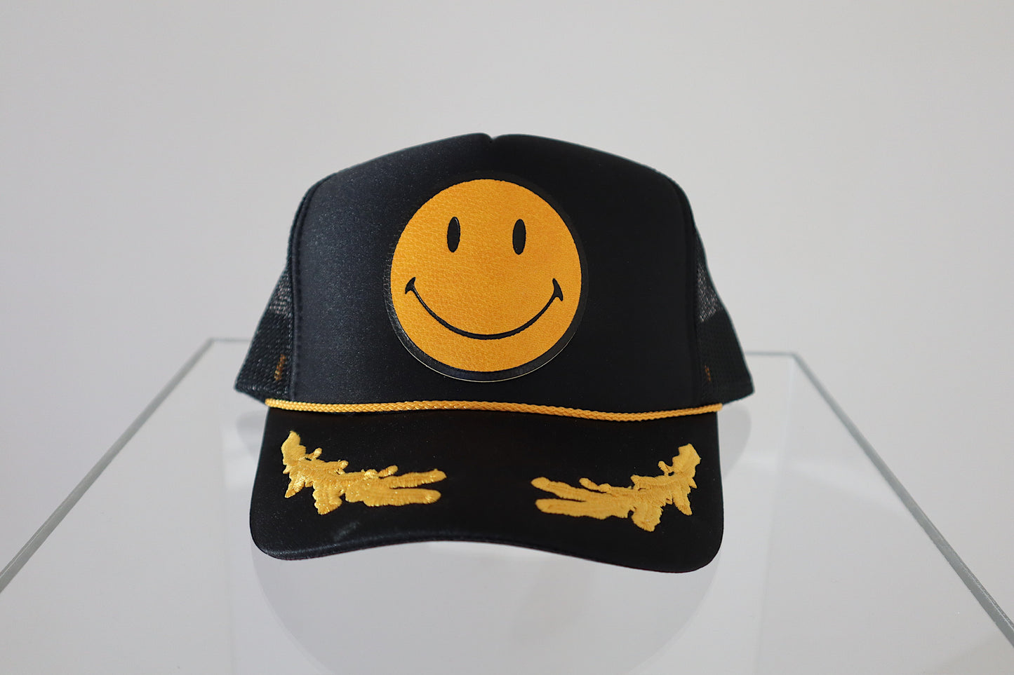 Smiley Yellow Leather On Black and Gold Leaf Trucker Hat