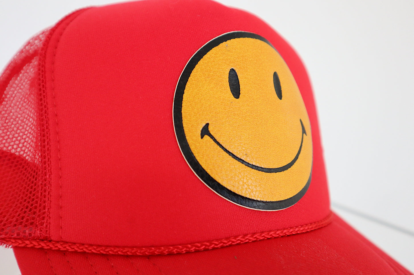 Smiley Yellow Leather on Red Trucker Hat